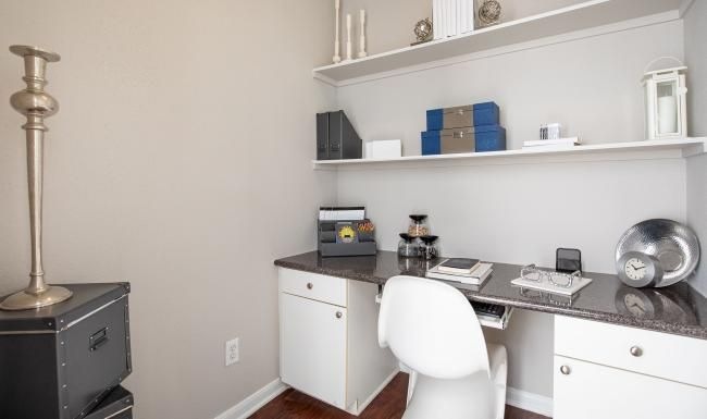a white desk with a chair and a white chair