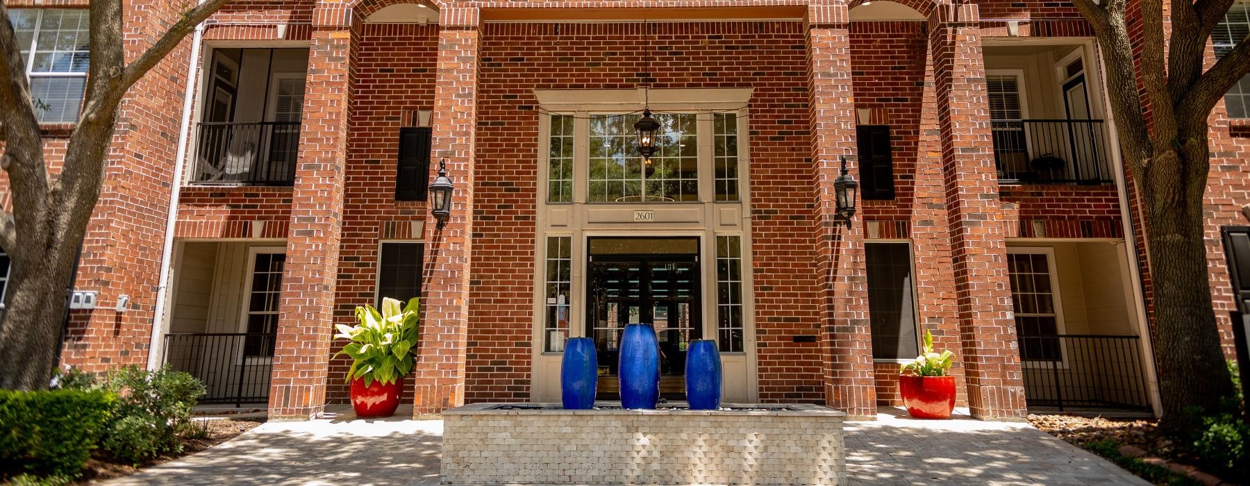 a brick building with vases in front of it